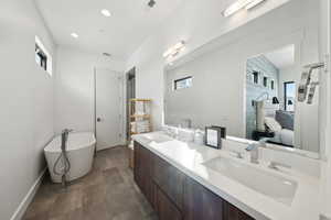 Primary bath ensuite with stand-alone soaking tub.