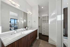 Primary bath featuring dual vanity and spacious walk-in closet