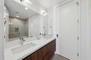 Full bathroom featuring dual vanity,  shower combination