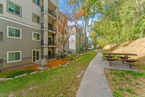 Surrounding community with a yard and a patio area