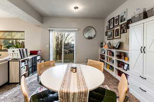 Dining room with plenty of natural light and carpet floors