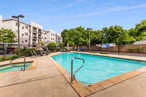 View of pool with a hot tub and a patio