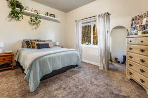 Carpeted bedroom with a textured ceiling