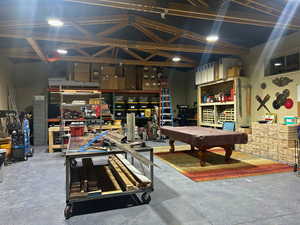 Workshop with epoxy floor, shelves, large air compressor, 30 amp outlet and 50 amp outlet.