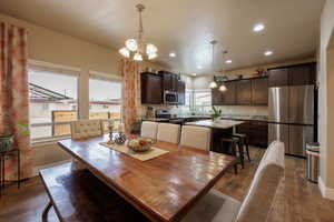 Dining space with dark hardwood / wood-style flooring and granite countertop