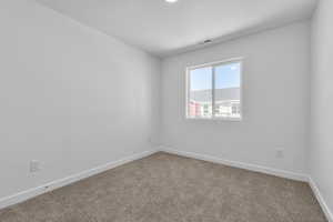 Spare room with carpet and a textured ceiling