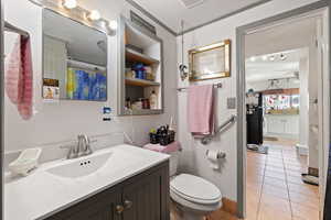 Bathroom featuring vanity, toilet, and tile patterned flooring