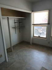 Unfurnished bedroom with dark tile patterned floors