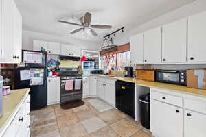 Kitchen featuring white cabinetry, ceiling fan, sink, and black appliances