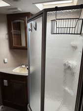 Bathroom with vanity and a shower with shower door