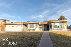 View of front of home featuring a garage and a front lawn