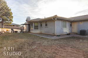 Back of property with central AC and a pergola