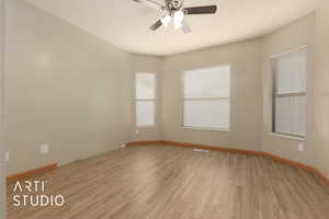 Empty room featuring ceiling fan and light wood-type flooring