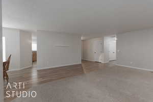 Carpeted empty room with a textured ceiling