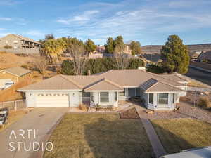 Ranch-style house with a garage and a front lawn