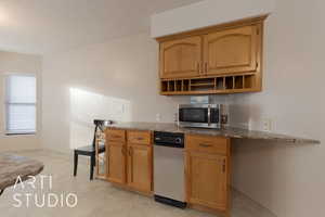 Kitchen featuring light stone counters