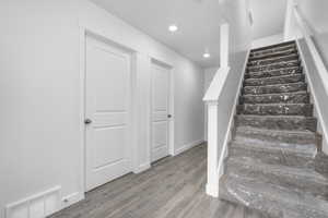 Staircase with hardwood / wood-style floors