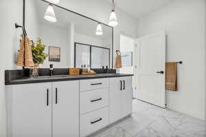 Bathroom with vanity and a shower with shower door