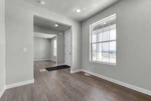 Foyer entrance with a wealth of natural light, baseboards, recessed lighting, and hardwood / wood-style flooring