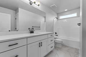 Bathroom with visible vents, toilet, marble finish floor, shower / bathing tub combination, and vanity