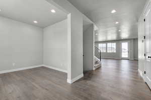 Unfurnished room with stairway, recessed lighting, wood finished floors, and baseboards