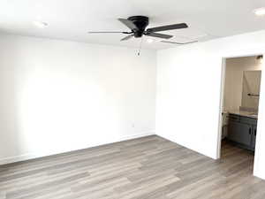 Empty room featuring ceiling fan and light wood-type flooring