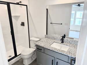 Bathroom with walk in shower, wood-type flooring, toilet, and vanity