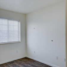 Spare room featuring dark hardwood / wood-style floors