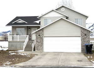 View of front of home featuring a mountain view and covered porch