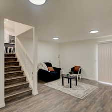 Living room with dark wood-type flooring