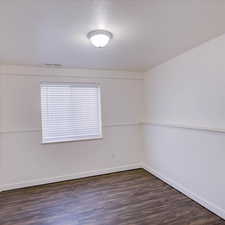 Spare room featuring dark wood-type flooring and a textured ceiling