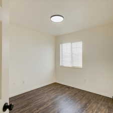 Spare room with dark hardwood / wood-style floors