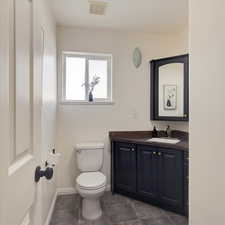 Bathroom featuring vanity and toilet