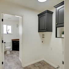 Clothes washing area with gas dryer hookup and hookup for an electric dryer