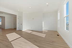 Spare room featuring light wood-type flooring