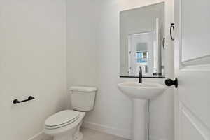 Bathroom featuring tile patterned flooring and toilet