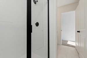 Bathroom featuring an enclosed shower and tile patterned flooring