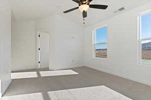 Spare room featuring lofted ceiling and light colored carpet