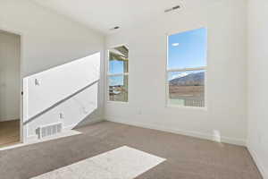 Spare room featuring light carpet and a mountain view