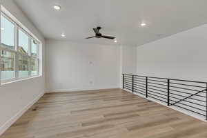 Unfurnished room featuring ceiling fan and light hardwood / wood-style flooring