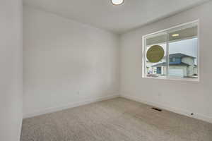 Unfurnished room featuring light carpet