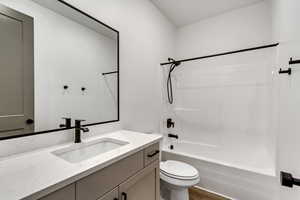 Full bathroom with shower / washtub combination, toilet, and vanity