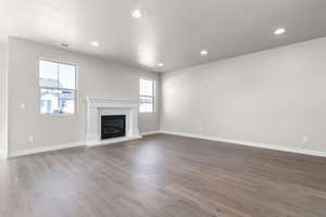 Unfurnished living room featuring a textured ceiling and light hardwood / wood-style flooring