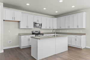 Kitchen featuring white cabinetry, appliances with stainless steel finishes, and sink