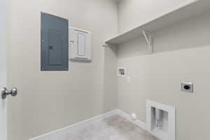 Clothes washing area featuring washer hookup, hookup for an electric dryer, electric panel, and hookup for a gas dryer