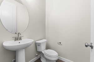 Bathroom with sink, toilet, and hardwood / wood-style floors