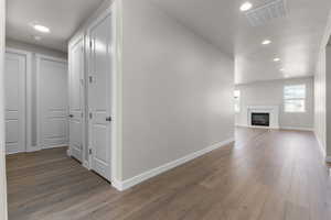 Hallway with dark hardwood / wood-style floors