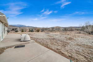 View of yard with a mountain view and a patio