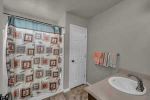 Bathroom with vanity and a textured ceiling