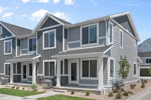 View of front facade featuring a porch, a mountain view, and cooling unit